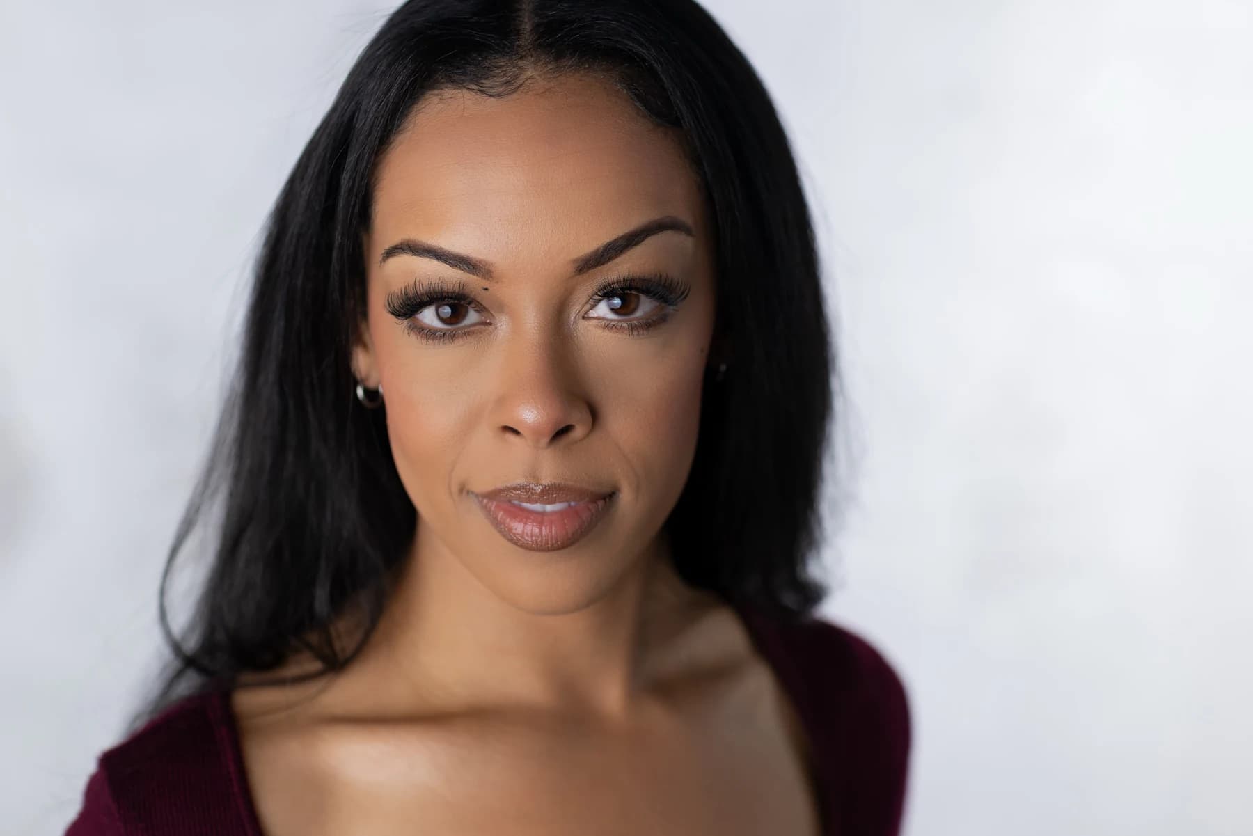 Landscape headshot of Aliyah Celeste in a burgundy top.